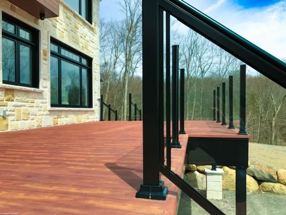 Modern wooden deck with black railings