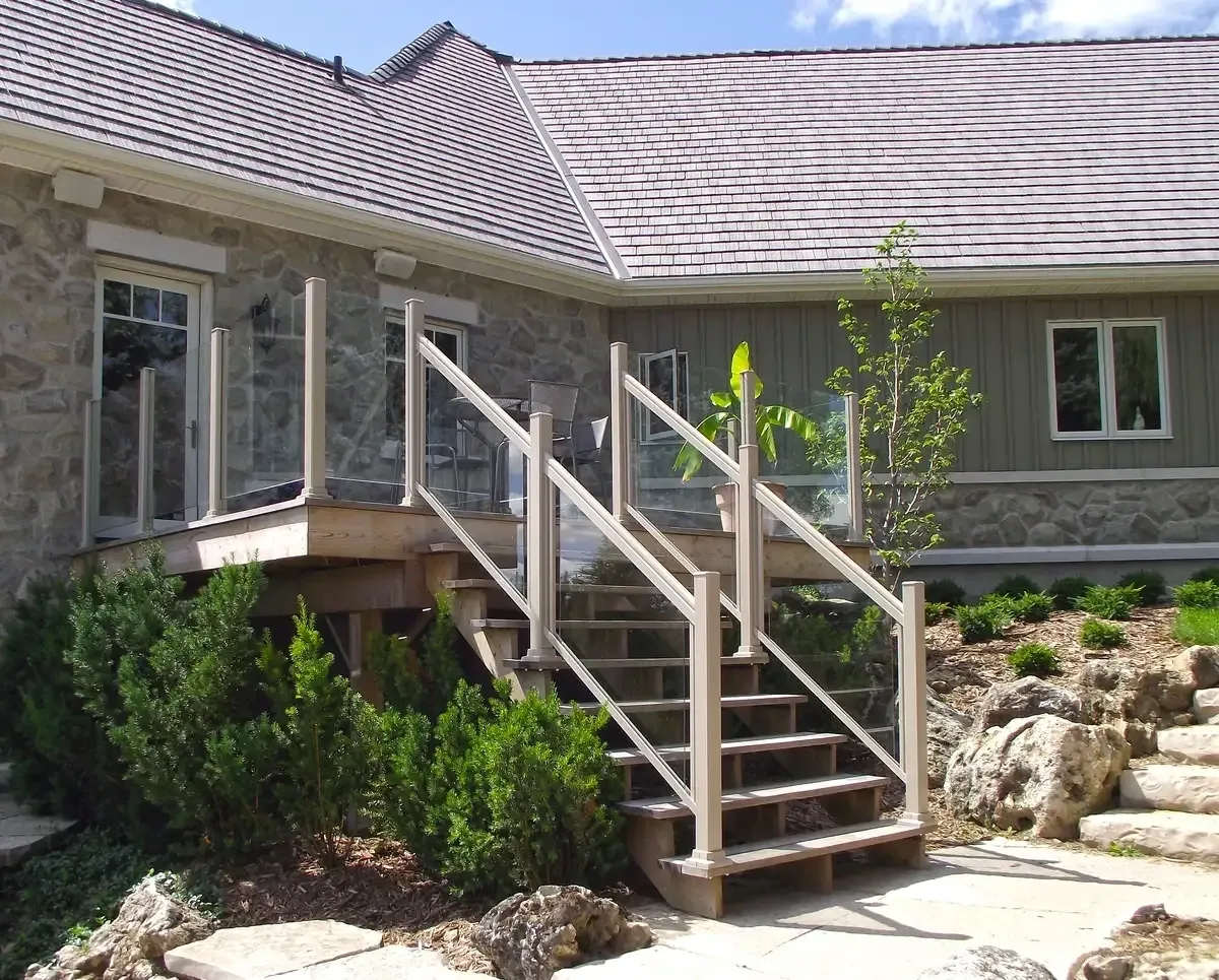 Stone house with wooden deck stairs