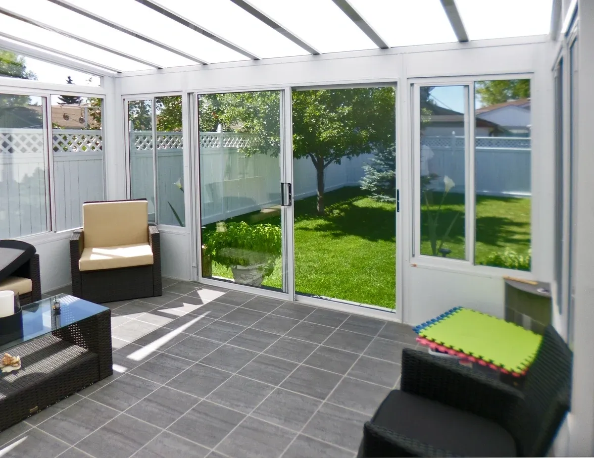 Cozy sunroom overlooking lush backyard