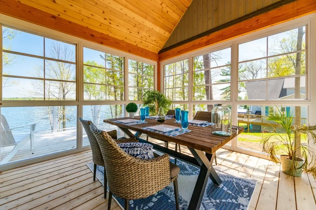Lakeside sunroom with dining setup