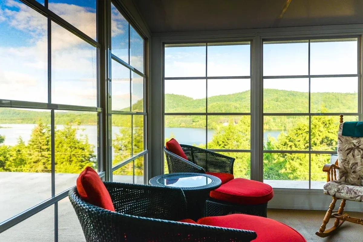 Cozy sunroom with scenic lake view