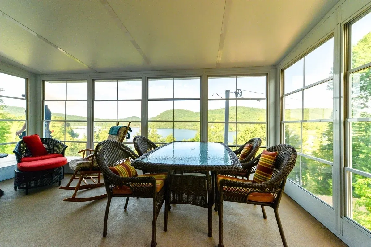 Enclosed sunroom with wicker furniture