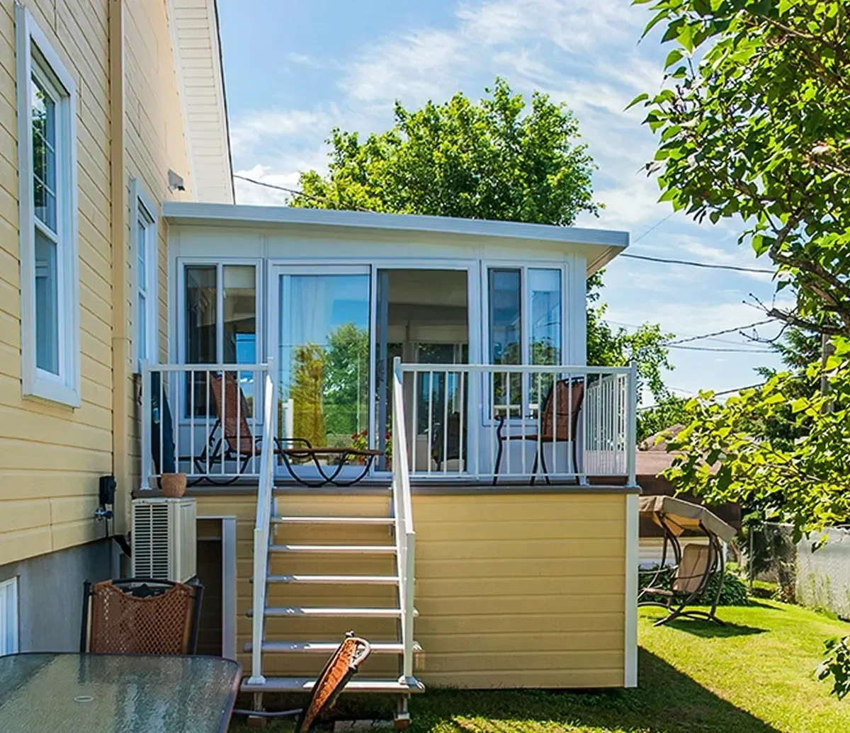 Sunroom with outdoor stairs and chairs