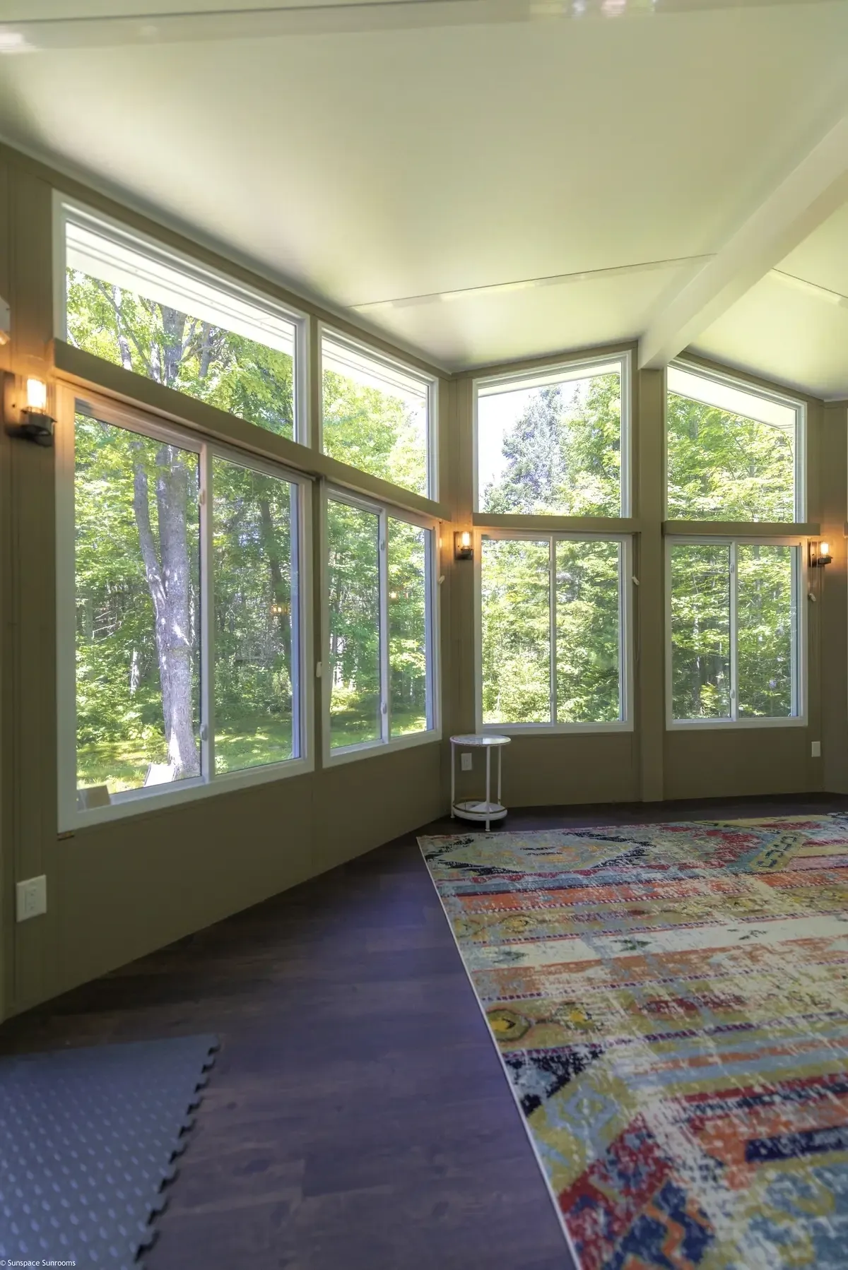 Sunlit interior with colorful patterned rug.