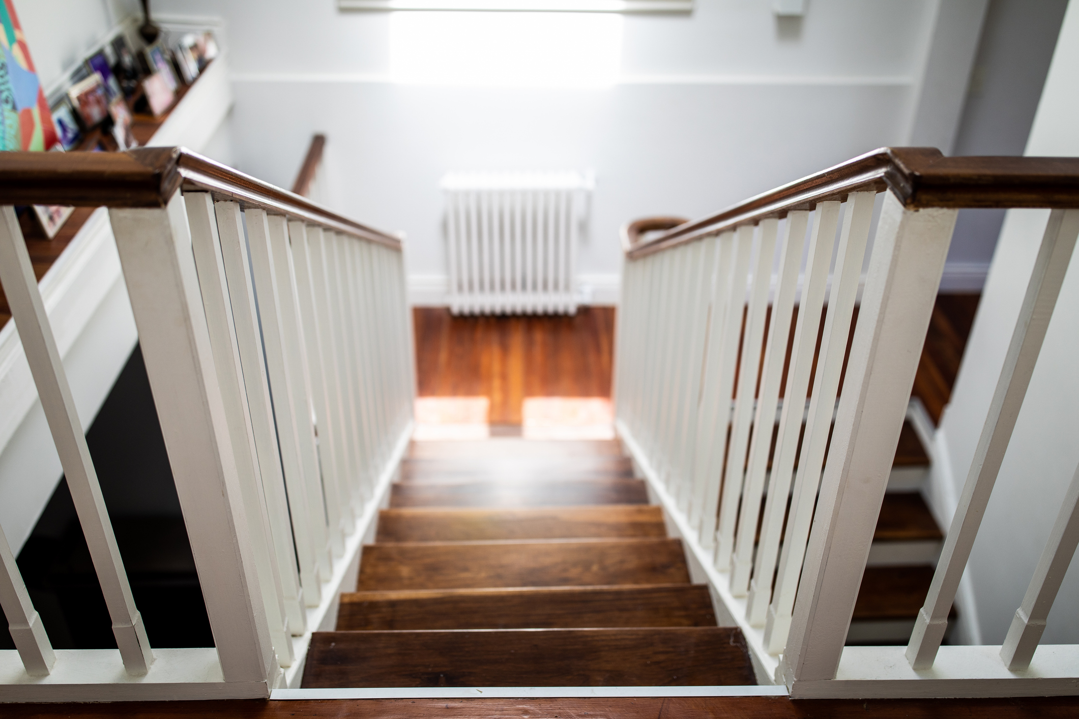 Modern wooden stairs and white walls, view from above