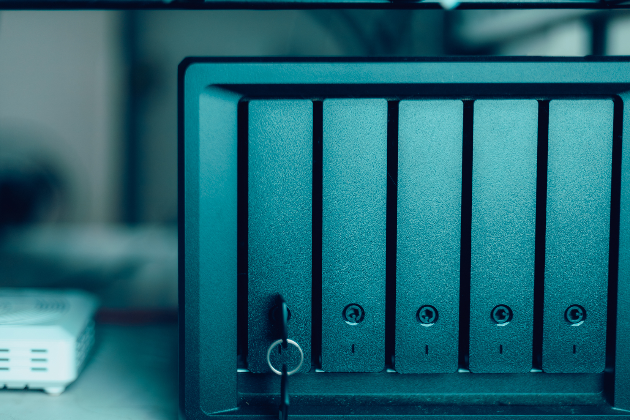 Close-up of NAS server storage system with multiple drive bays for data backup and cloud storage infrastructure.