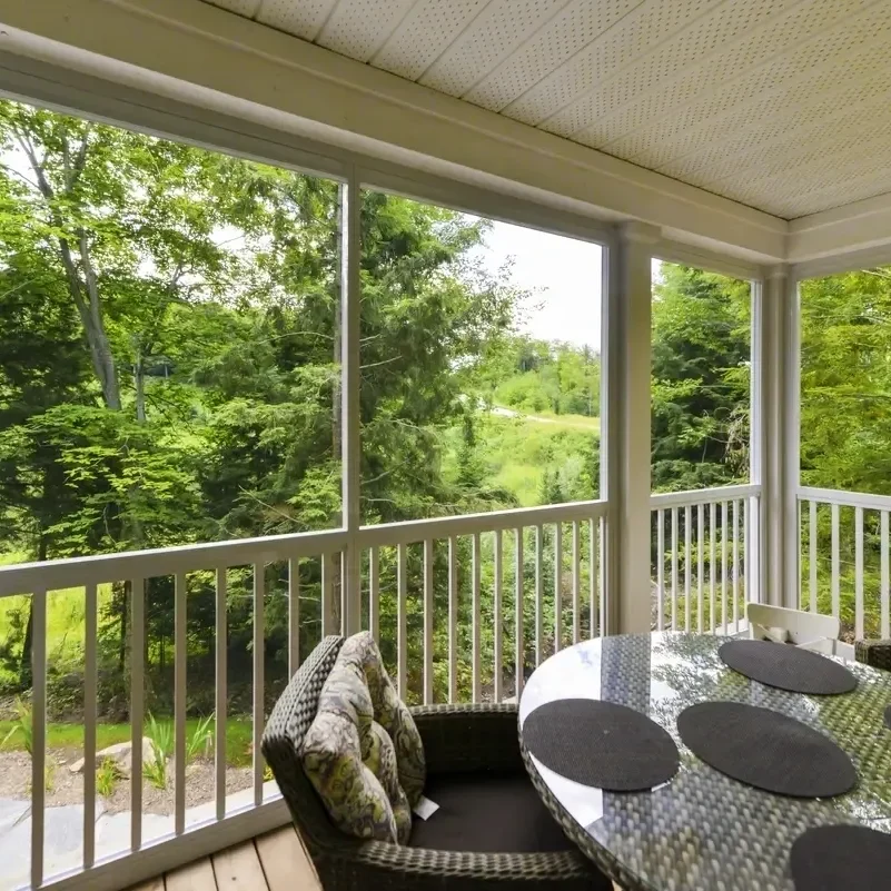 Screened porch overlooking lush green landscape